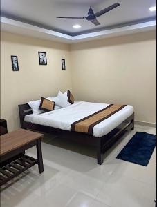 a bedroom with a bed with a ceiling fan at Kohua Bon - Kaziranga in Hatikhuli