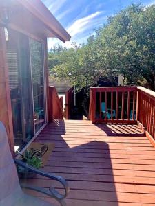 a large wooden deck with glass doors on a house at The Armadillo Cabin - Cabins At Rim Rock in Austin