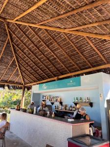 a group of people sitting at a bar in a restaurant at APT 2/4 LUXO IBEROSTATE in Praia do Forte