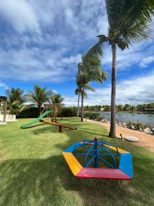 a park with a playground and a slide at APT 2/4 LUXO IBEROSTATE in Praia do Forte