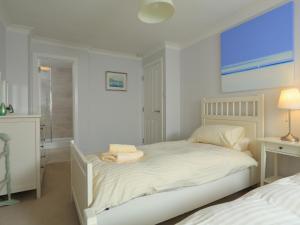 a white bedroom with a bed and a window at 2 Poundstone Court in Salcombe +23 photos