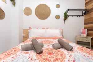a bedroom with a bed with two pillows on it at Big Room Happy Alicante in Alicante