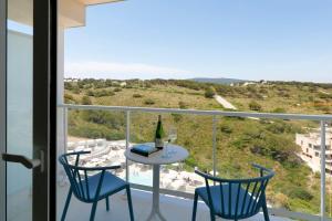 a room with a table and two chairs and a window at Palladium Hotel Menorca in Arenal d'en Castell