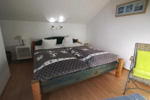a bedroom with a bed with a black and white blanket at Seeadler 3 - Süssau in Süssau