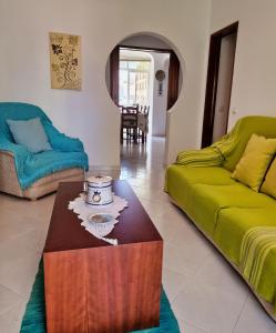 a living room with a couch and a coffee table at Tavira City Center 3Br in Tavira