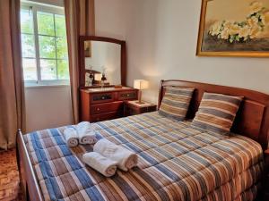 a bedroom with a bed with towels on it at Tavira City Center 3Br in Tavira