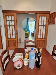 a dining room table with a bottle of water on it at Tavira City Center 3Br in Tavira