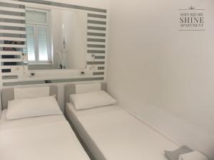 a room with two beds and a bath tub at Luxurios and historic apartment "Shine" - right on the Main Square in Zagreb