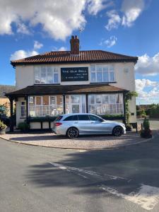 a car parked in front of a building at The Old Bell in Grimston