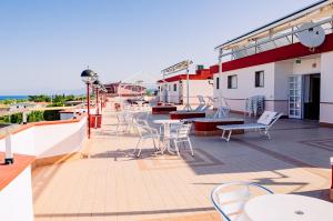 a patio with chairs and tables on a building at Apparthotel Residence Riviera dei Cedri in Santa Maria del Cedro