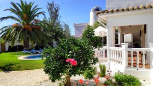 una casa blanca con una palmera y un patio en Villa Ola, en Los Caños de Meca