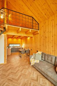 a living room with a couch and a table at Scandinave Chalet Bran in Zărneşti