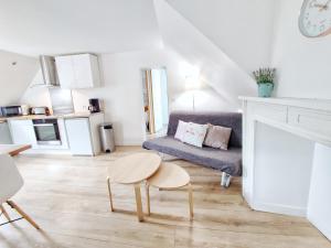 a living room with a couch and a table at L'Escale cocooning T3 Centre ville in Bagnères-de-Bigorre