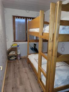 a room with three bunk beds in a room at Gîte à la ferme du Lomont 