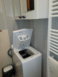 a washing machine in the corner of a bathroom at Gîte à la ferme du Lomont 
