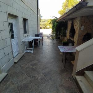 a patio with a table and a stone fireplace at Zana Apartments in Stari Grad