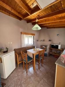 a kitchen and living room with a table and a couch at Tonia’s & Chris House in Kalliópi