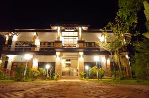 a house lit up at night with a driveway at Above The Sea Maesariang in Mae Sariang