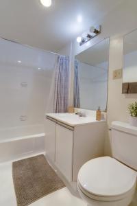 a bathroom with a toilet and a sink and a tub at Great 1 Bedroom Condo At Arlington With Gym in Arlington