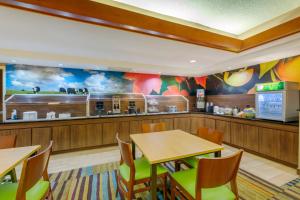 a fast food restaurant with tables and a kitchen at Quality Inn & Suites Sandusky in Sandusky
