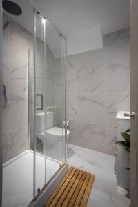 a glass shower in a bathroom with a toilet at Ocean View Apartments - Chelsea in Blackpool