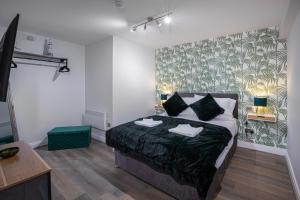 a bedroom with a bed with two towels on it at Ocean View Apartments - Belgravia in Blackpool