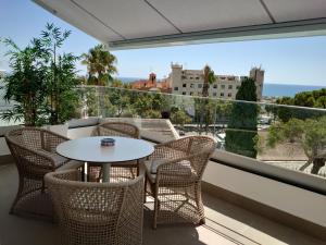 a patio with a table and chairs on a balcony at New build modern ap 4 min walk to the beach and Marbella old town in Marbella