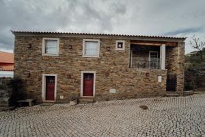 a brick house with red doors on a brick road at Forno House in Pereiros +41 photos