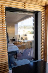 a sliding glass door with a view of a living room at mariaAPPARTMENTS in Gramatneusiedl