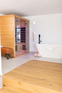 a bathroom with a wooden cabinet and a tub at mariaAPPARTMENTS in Gramatneusiedl