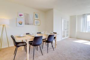 a dining room with a wooden table and chairs at Cozy 2 BR Apartment At Arlington With Gym in Arlington