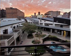 a view of a city from a balcony of a building at Maboneng Craftsmanship place in Johannesburg