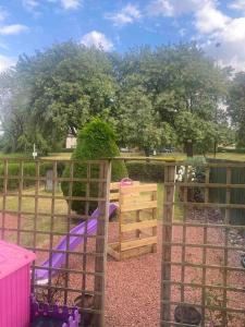 a playground with a purple slide in a park at Lovely 2 bedroom with private garden in Edinburgh