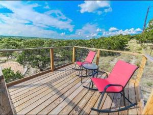 twee stoelen en een tafel op een terras bij The Coyote Cabin - Cabins at Rim Rock in Austin