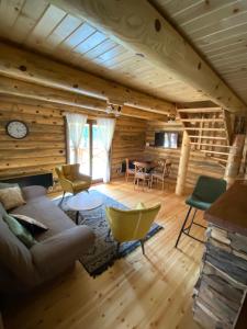 a living room with a couch and a table at Brvnare Park Borova in Zlatibor