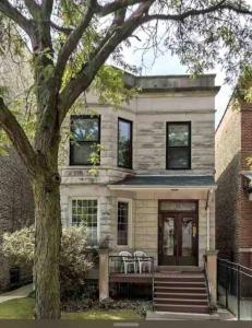 a house with a porch with chairs and a tree at The Wrigleyville VIP-200 Steps from Wrigley Field in Chicago