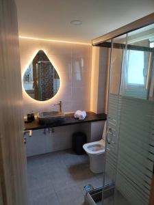 a bathroom with a sink and a toilet and a mirror at THROUBI VILLA in Agia Galini +23 photos