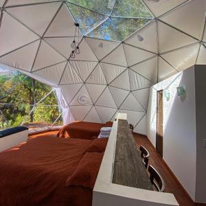 a room with a large bed in a tent at Cool Glamping La aventurosa in Toluca