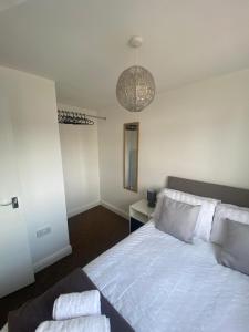 a bedroom with a bed with two towels on it at Spacious 1 Bedroom Apartment with free parking in Wednesbury