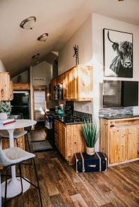 a kitchen with wooden cabinets and a counter top at The Bison Cabin - The Cabins at Rim Rock in Austin