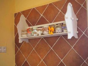 a shelf on a wall with items on it at Casa Rural El Guindo in Avila