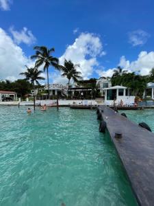 a pool at a resort with people in the water at Hotel Aldea 19 Bacalar in Bacalar