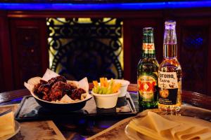 a table with a tray of food and a bottle of beer at Quinta del Rey Hotel in Toluca