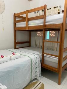 two bunk beds in a room with a bed at Pousada Paracuru Surf in Paracuru