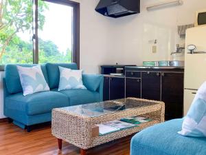 a living room with a blue couch and a table at Kāchibai - Vacation STAY 21657v in Tōzato