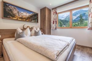 a bedroom with a bed with a view of mountains at Apart ALP in Kals am Großglockner