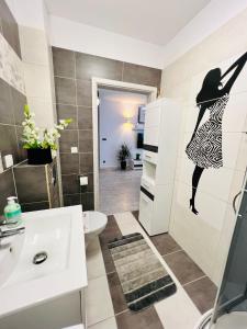 a bathroom with a white sink and a toilet at Apartament Eva 2 in Jelenia Góra