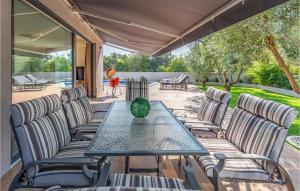 a patio with a table and chairs on a deck at Beautiful Home In Porec With Kitchen in Poreč