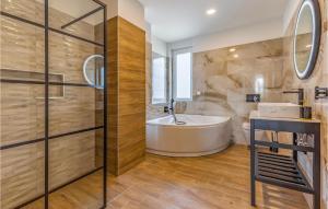 a bathroom with a tub and a sink at Beautiful Home In Porec With Kitchen in Poreč +52 photos