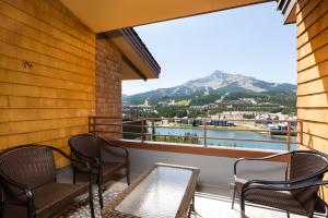 a balcony with chairs and a view of a mountain at Skycrest Penthouse 1733 in Big Sky